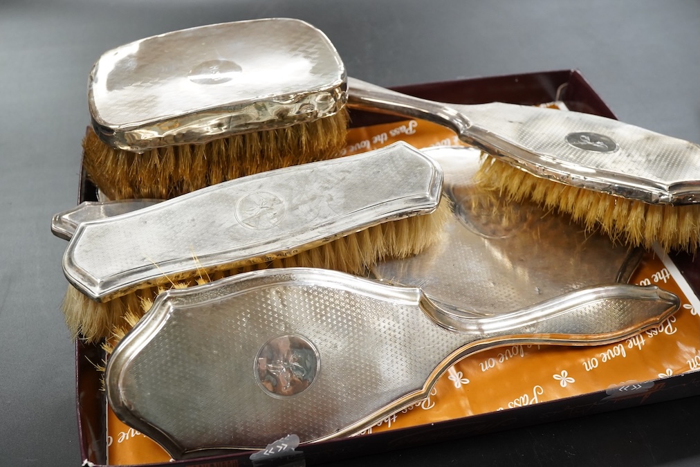 A George V silver engine turned four piece dressing table set and a pair of clothes brushes hand mirror length 19.3cm.